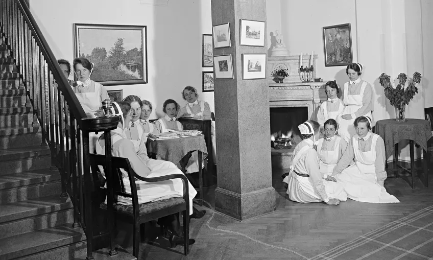 Sjuksköterskor sitter i en salong. Foto.